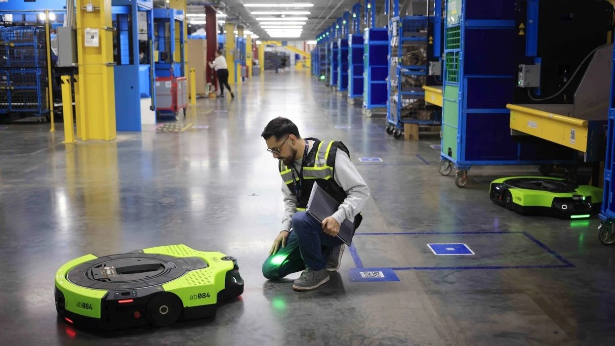 amazon worker fixing a robot